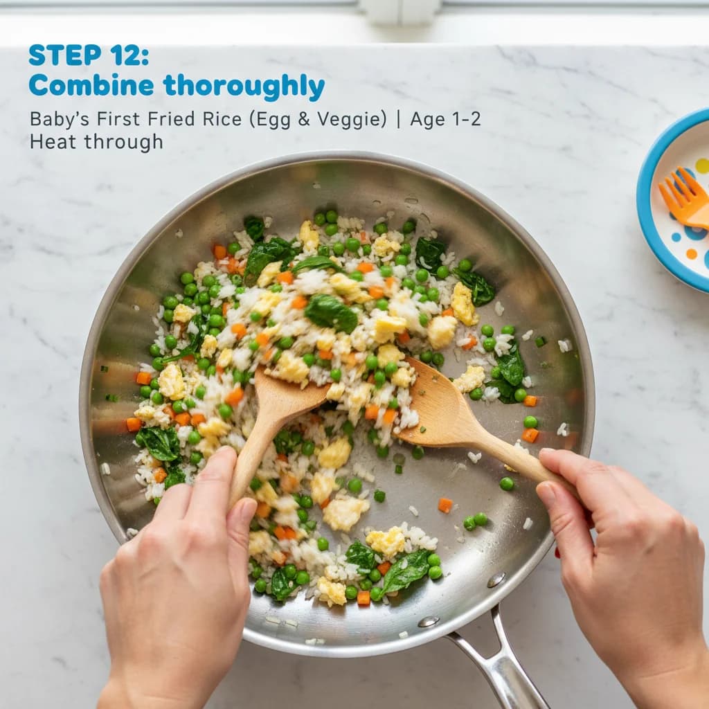 Step 12: Combine thoroughly: Toss everything together to combine evenly, ensuring the egg is distributed thro for Baby's First Fried Rice (Egg & Veggie)